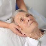 An older lady receiving cranial osteopathy / craniosacral therapy treatment