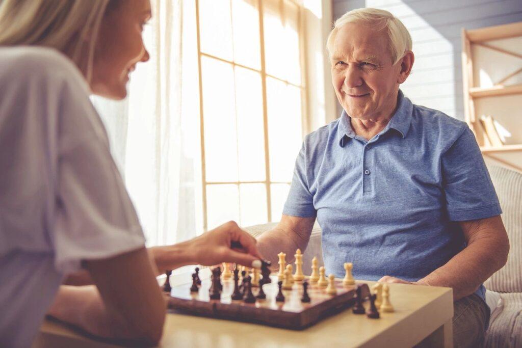 Older man playing chess who may need Osteopathy for Arthritis type pains